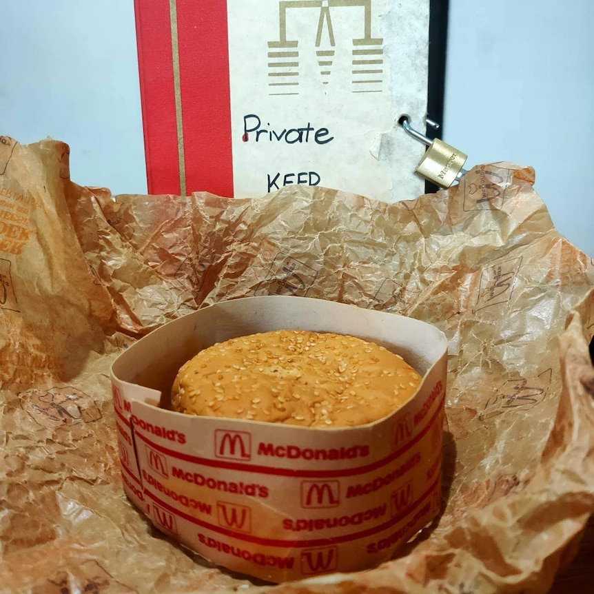 Senior Burger in its printed cardboard ring and crumpled wrapper.